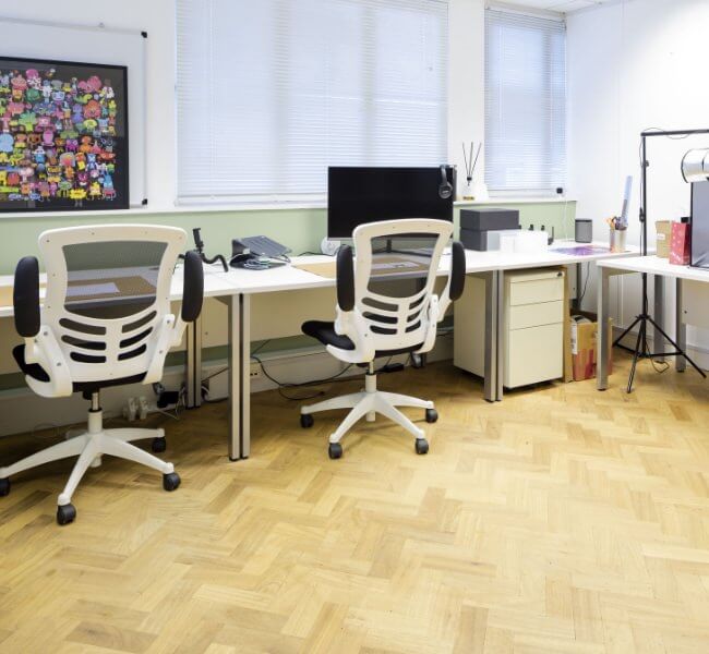 Serviced office in woking with two desks, chairs and screens for business use with a photography station