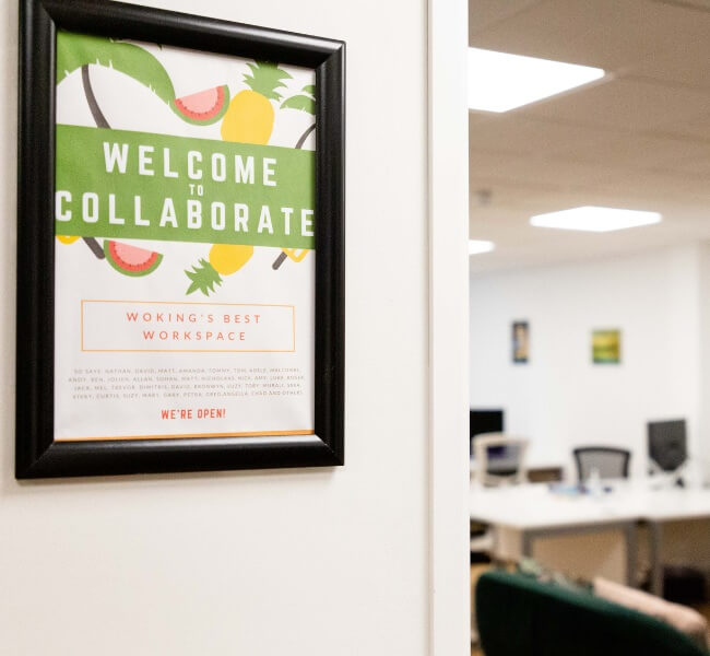 sign saying welcome to collaborate in a coworking area in woking