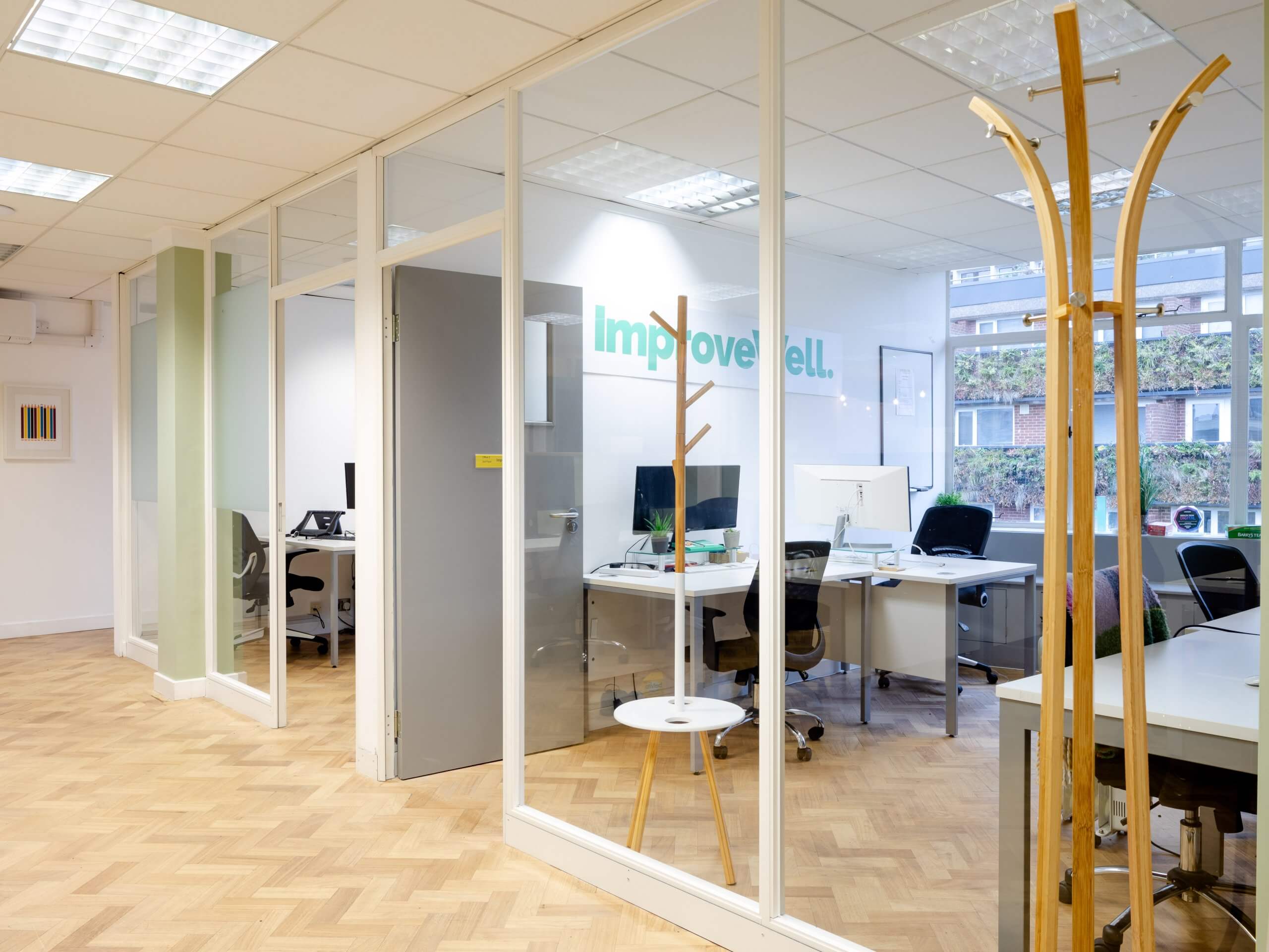An outside shot of an office behind a glass wall.