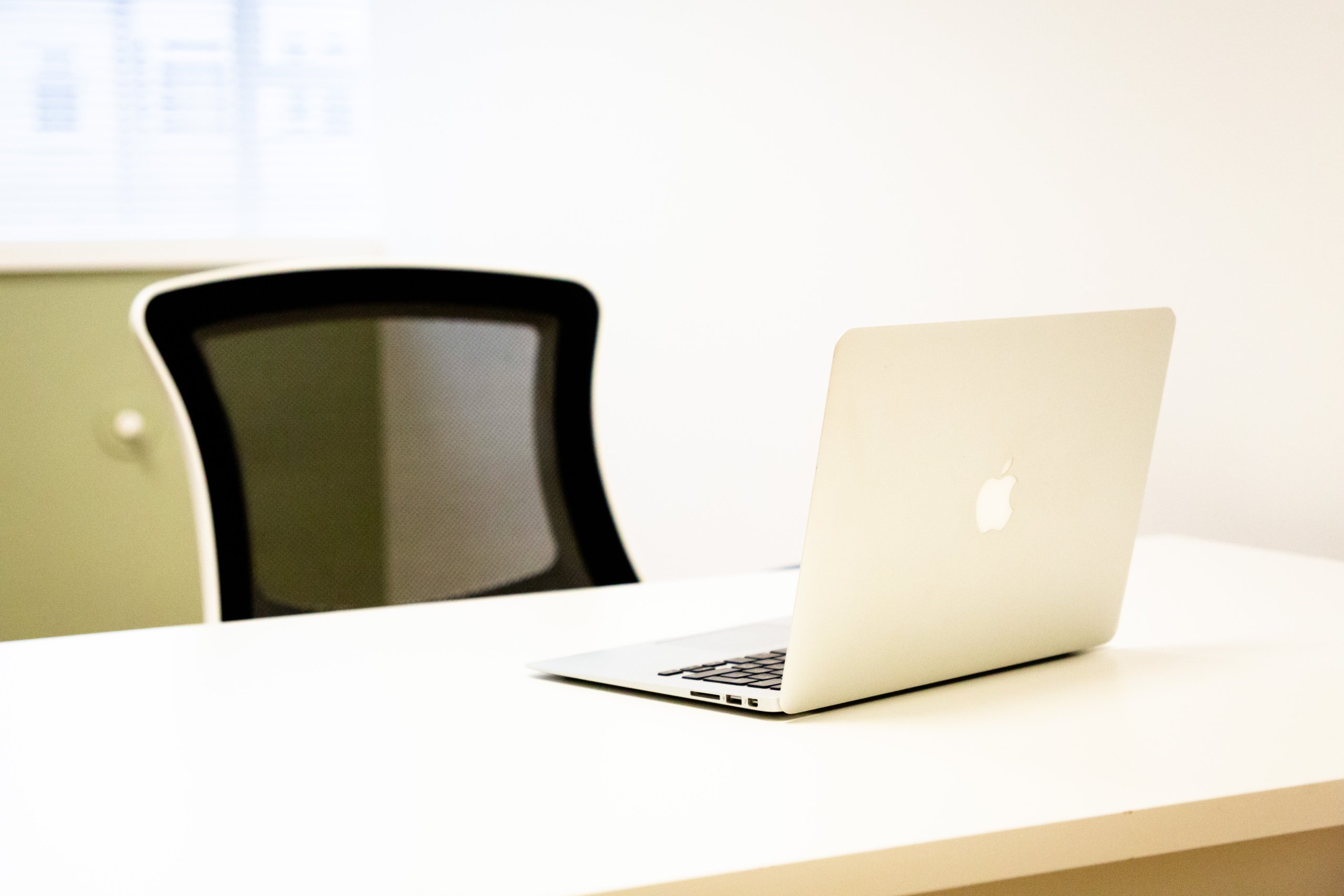Virtual office setup with a computer on a white desk